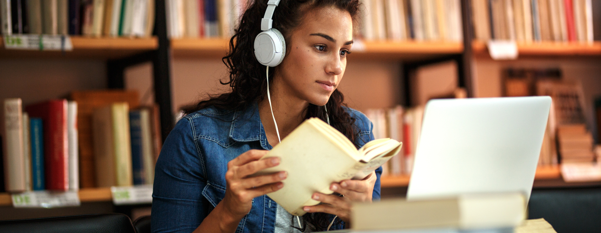 Girl on computer with headphones