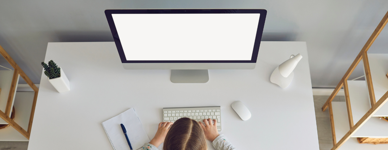 Teen girl sitting at her desk on the computer